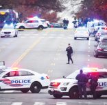 Police secure the scene near Comet Ping Pong in Washington, Sunday, Dec. 4, 2016. A man who said he was investigating a conspiracy theory about Hillary Clinton running a child sex ring out of the pizza place fired an assault rifle inside the restaurant on Sunday injuring no one, police and news reports said. (Photo by Sarah L. Voisin/The Washington Post via AP)