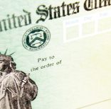 FILE - This May 8, 2008, file photo shows blank checks on an idle press at the Philadelphia Regional Financial Center, which disburses payments on behalf of federal agencies, in Philadelphia.  Congressional auditors say about 30 million people will have to come up with more money to pay their taxes next year because their employers withheld too little from their paychecks under government tables keyed to the new tax law. New tax withholding tables for employers were put together by the government early 2018.   (AP Photo/Matt Rourke, File)